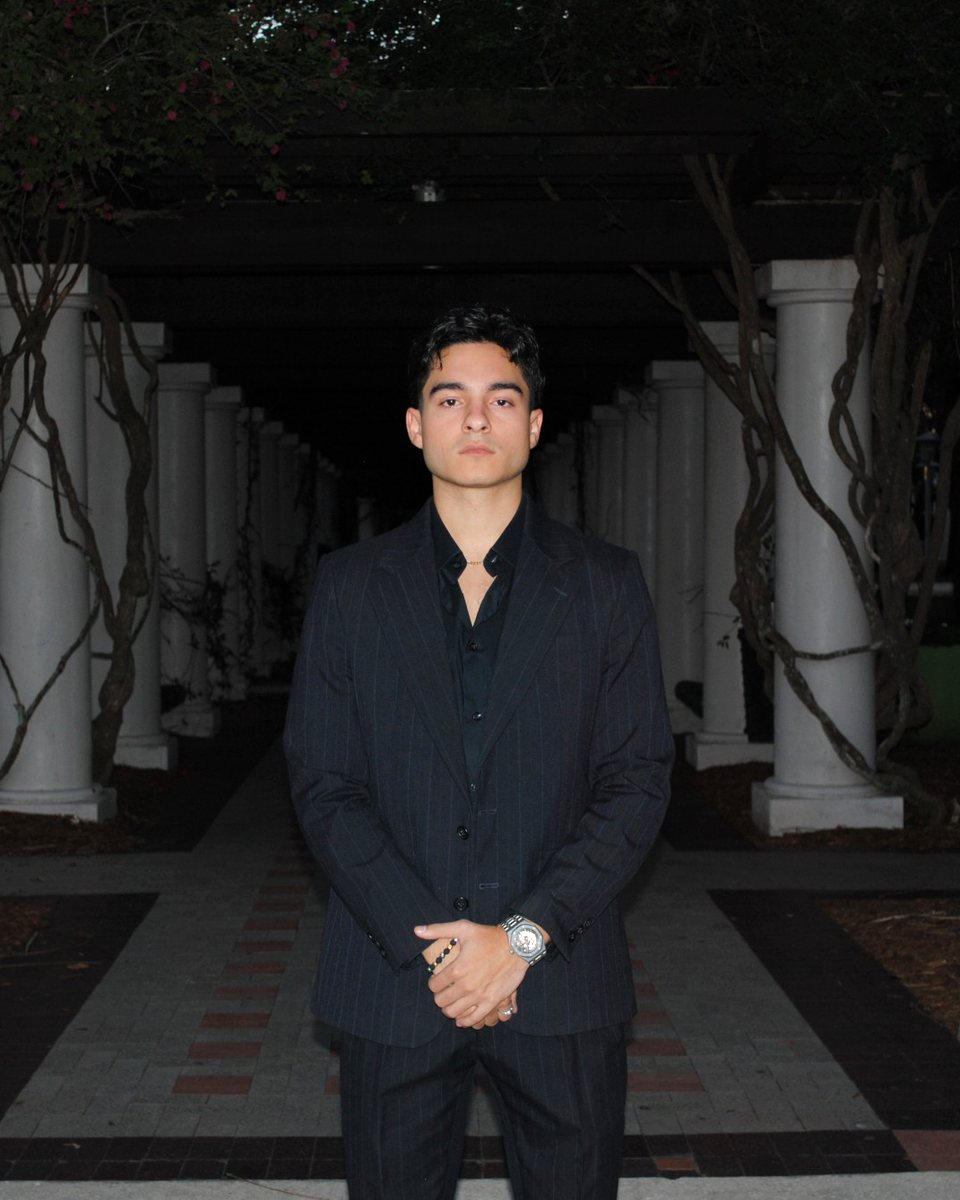 Stephano De Andreis, Founder and CEO of De Andreis Enterprises, in a black pinstripe suit